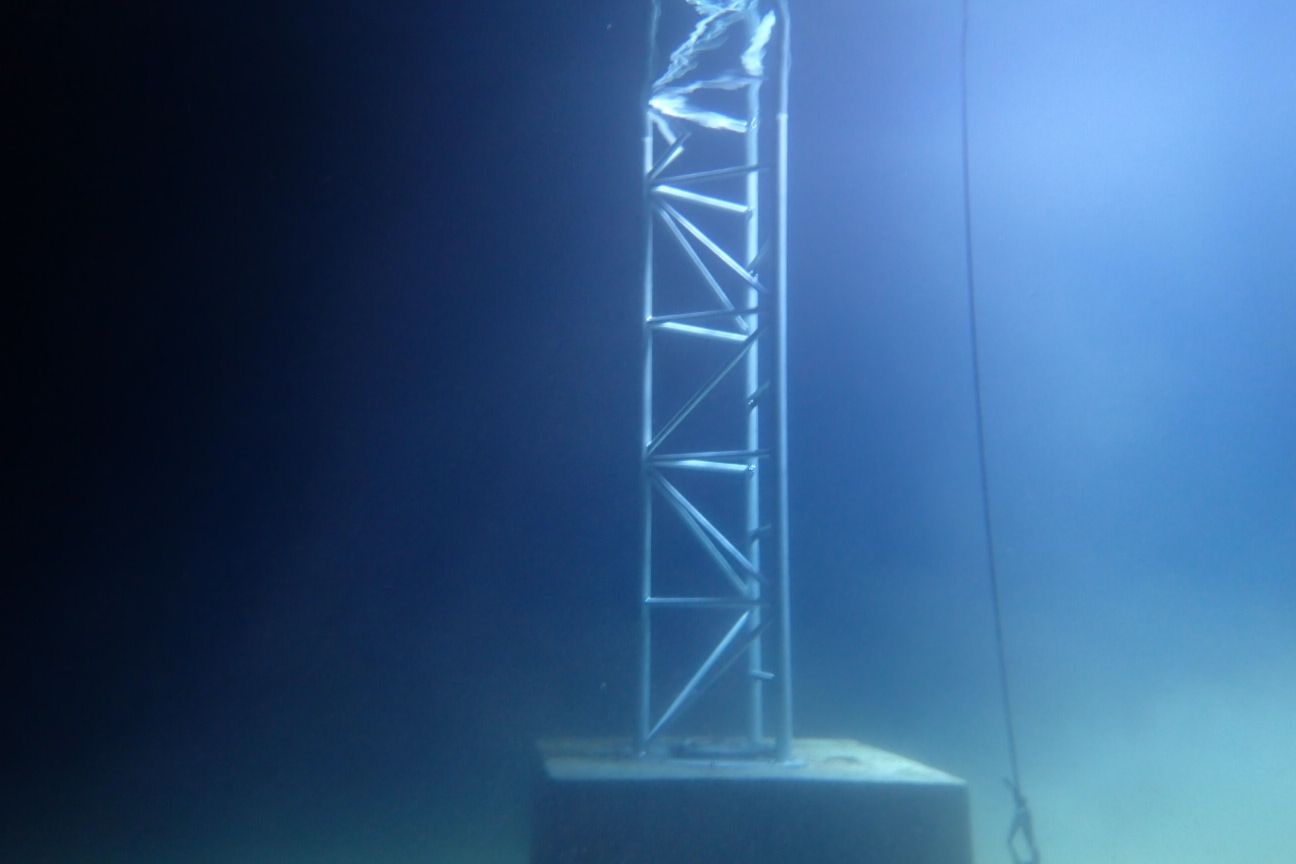 Replacement Aquapost standing on its concrete base underwater inside a reservoir