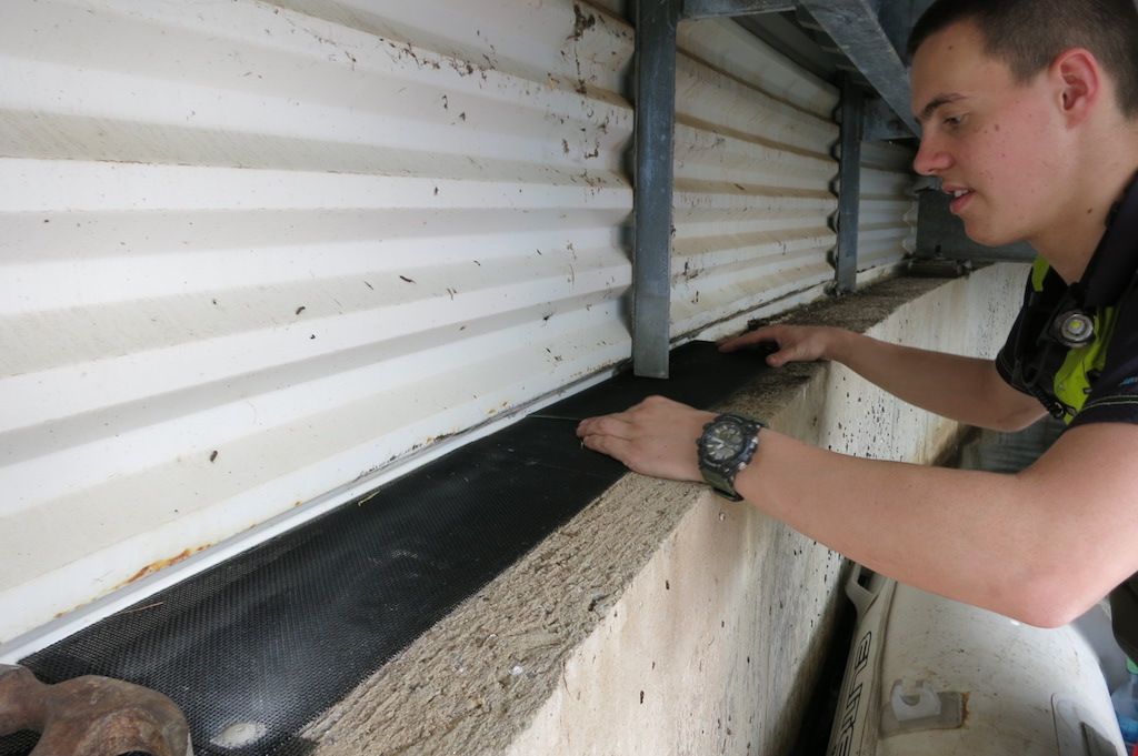 Installing bird proofing on a reservoir from an inflatable boat