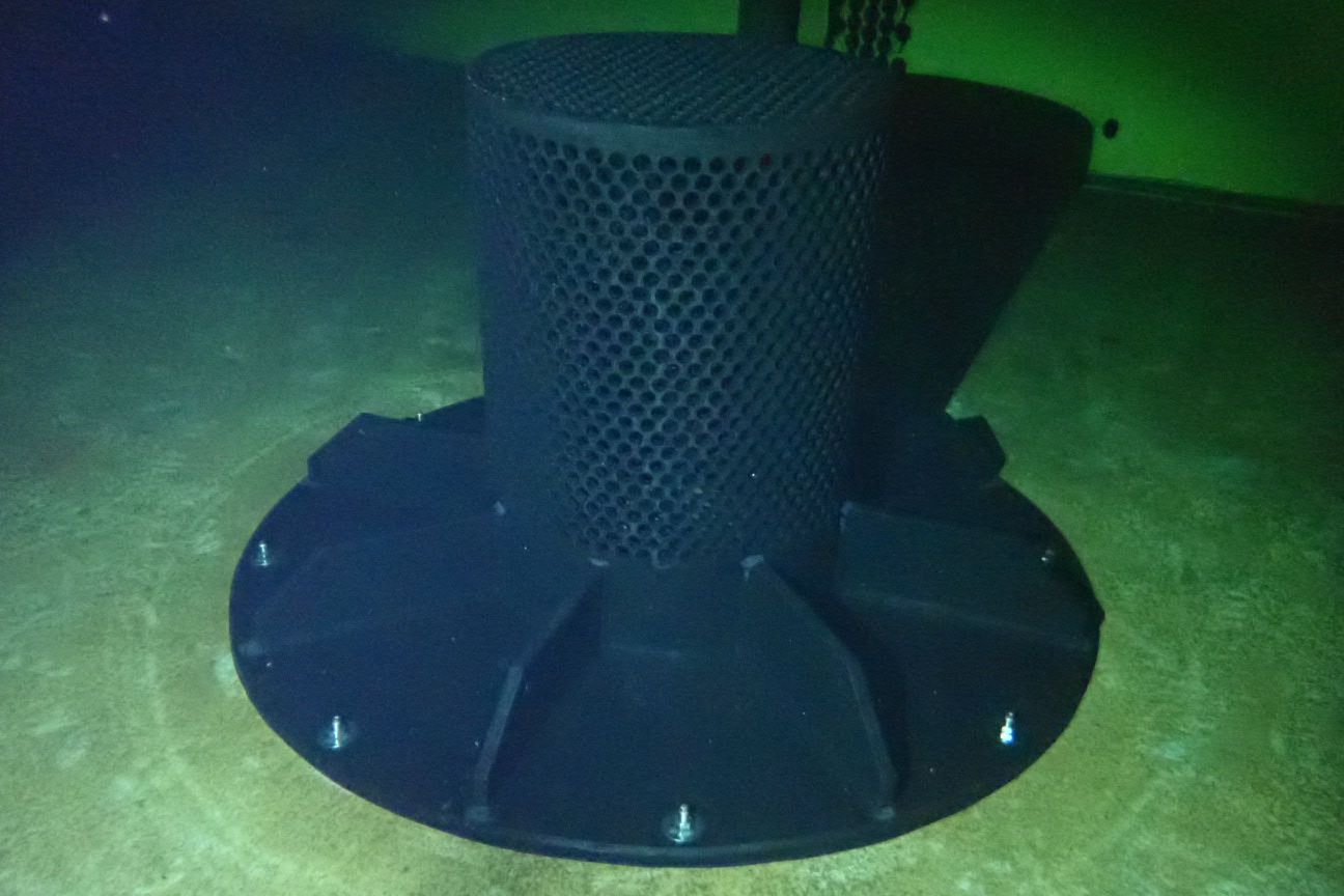 HDPE outlet safety screen with riser base installed on a reservoir floor