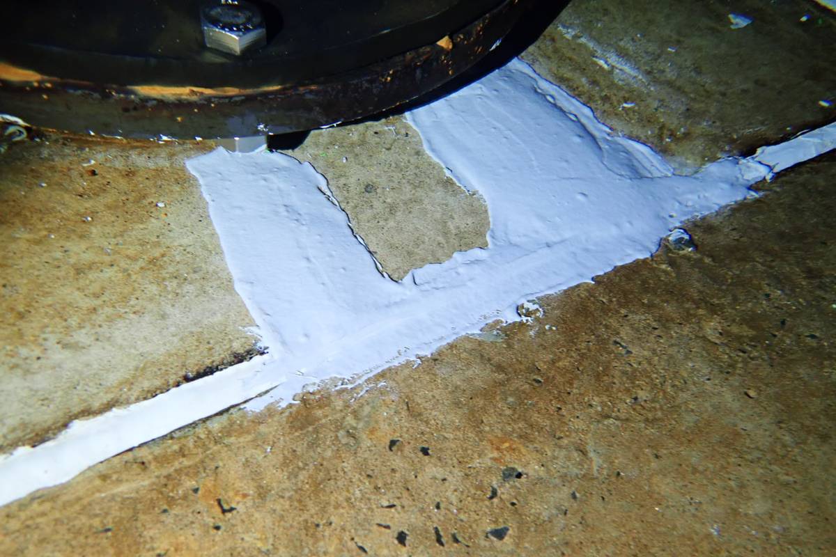 Repair patches applied to a reservoir floor around a structure base