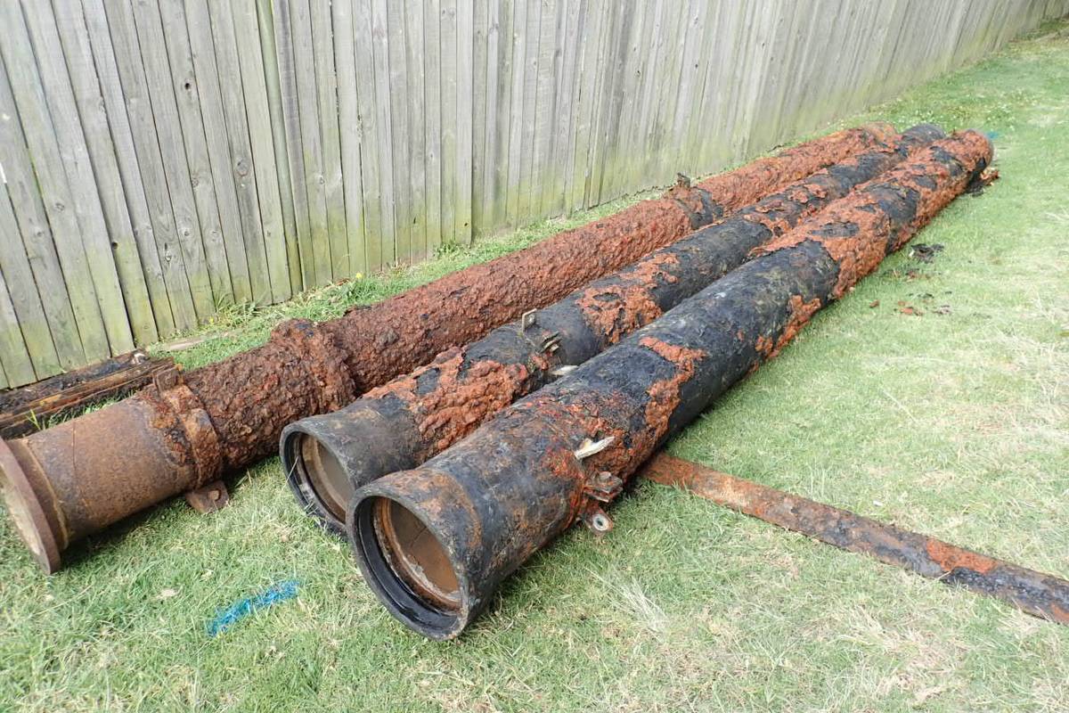Corroded pipework sections removed from a reservoir and laid out on site